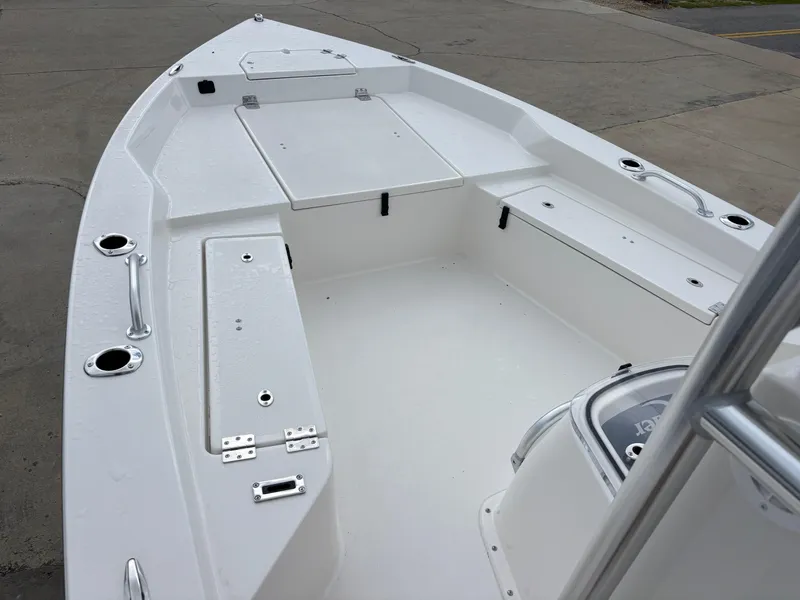 Slide: The Image of 2026 Bay Rider 239 Bay boat interior with storage compartments and rod holders. - 20