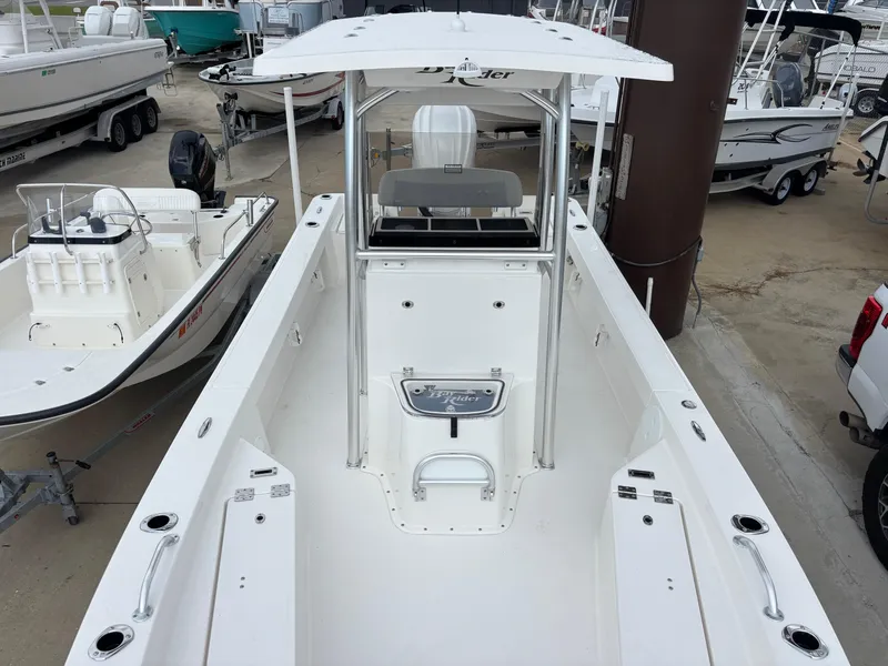 Slide: The Image of 2026 Bay Rider 239 Bay boat, white interior, docked among other boats. - 21