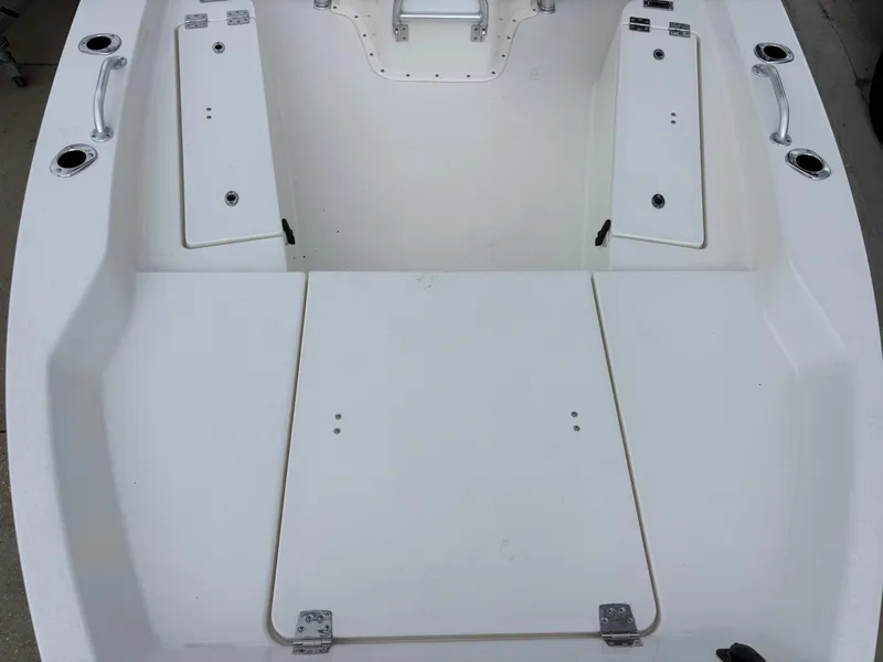 Slide: The Image of 2026 Bay Rider 239 Bay boat interior with storage compartments and handles. - 23