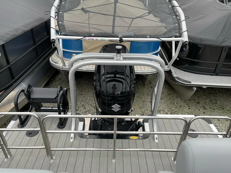 Slide: The Image of 2025 Bentley Pontoons Legacy 243 QSB with Suzuki outboard motor, rear view. - 11