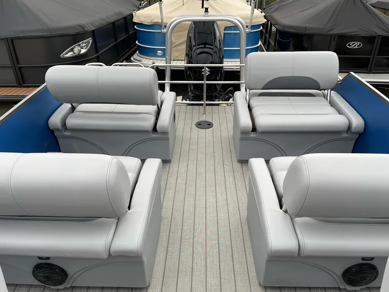 Slide: The Image of 2025 Bentley Pontoons Legacy 243 QSB interior with gray seating and blue accents. - 14