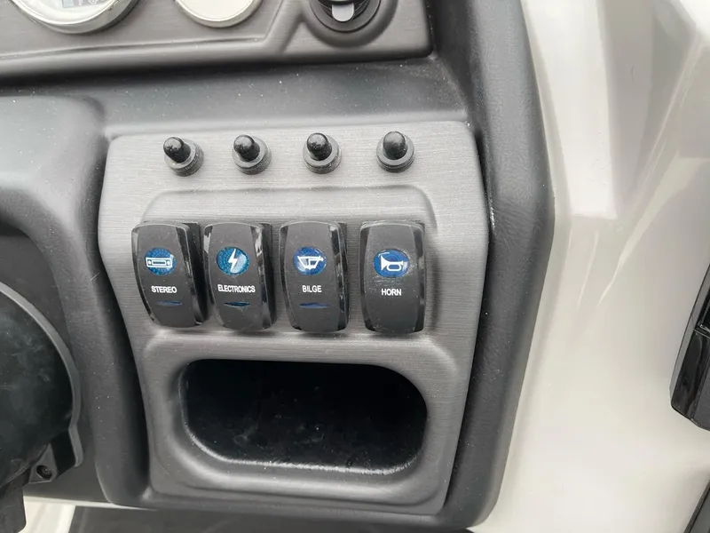 Slide: The Image of Control panel of 2025 Bentley Pontoons Legacy 243 QSB with labeled switches. - 19