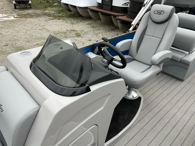 Slide: The Image of 2025 Bentley Pontoons Legacy 243 QSB interior with steering console and luxurious seating. - 21