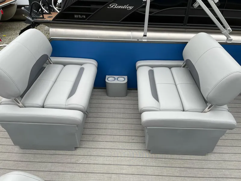 Slide: The Image of 2025 Bentley Pontoons Legacy 243 QSB interior with gray seating and cup holders. - 23