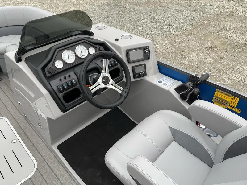Slide: The Image of 2025 Bentley Pontoons Legacy 243 QSB dashboard with steering wheel and controls. - 6