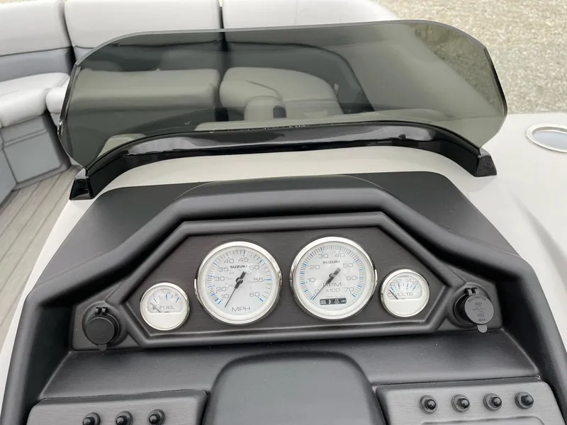 Slide: The Image of 2025 Bentley Pontoons Legacy 243 QSB dashboard with gauges and controls. - 7