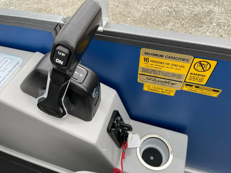 Slide: The Image of Control panel of 2025 Bentley Pontoons Legacy 243 QSB with capacity warning labels. - 9