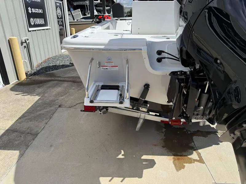 Slide: The Image of 2026 Sea Pro 250 Bay boat rear view with motor and ladder. - 10