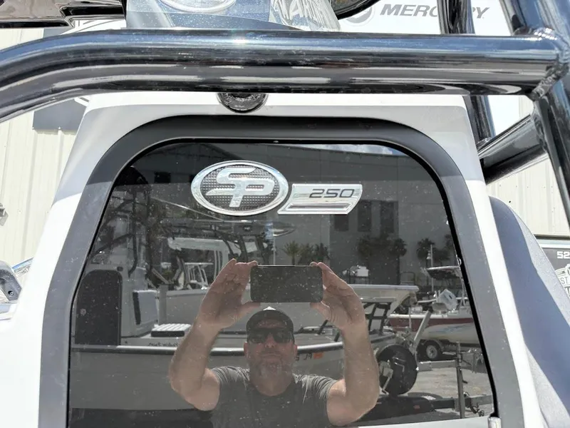 Slide: The Image of 2026 Sea Pro 250 Bay boat with reflective surface and logo. - 6