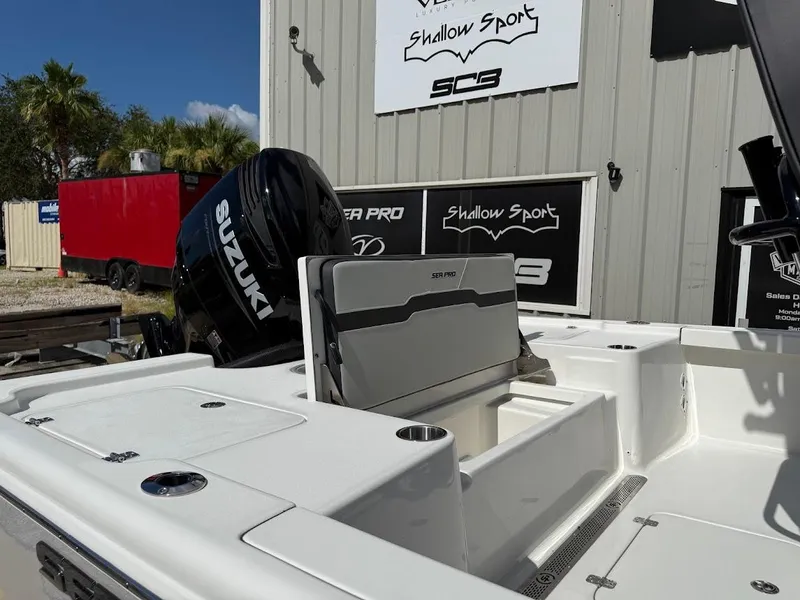 Slide: The Image of 2026 Sea Pro 250 Bay boat with Suzuki engine, displayed outdoors. - 7