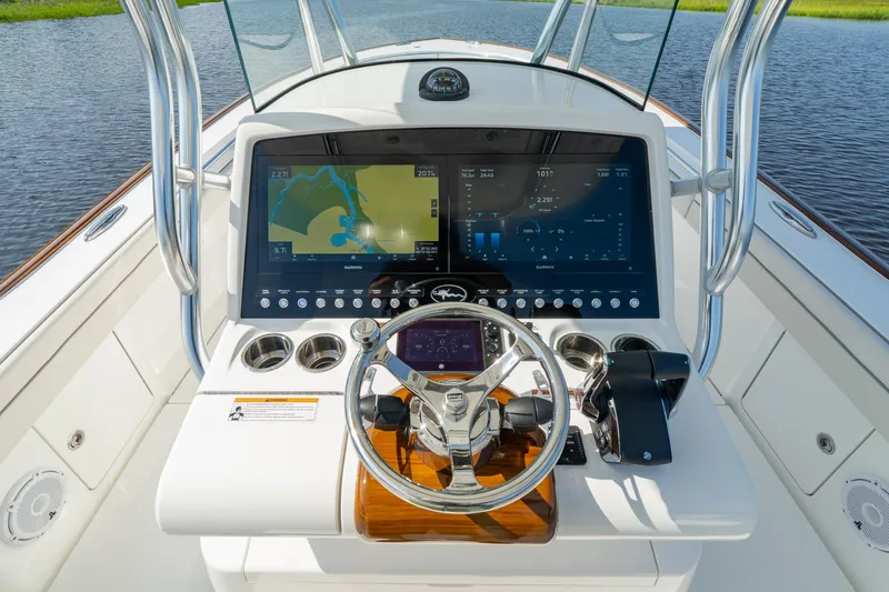 Slide: The Image of Valhalla Boatworks V-29 Hybrid 2025 helm with advanced navigation display and controls. - 10