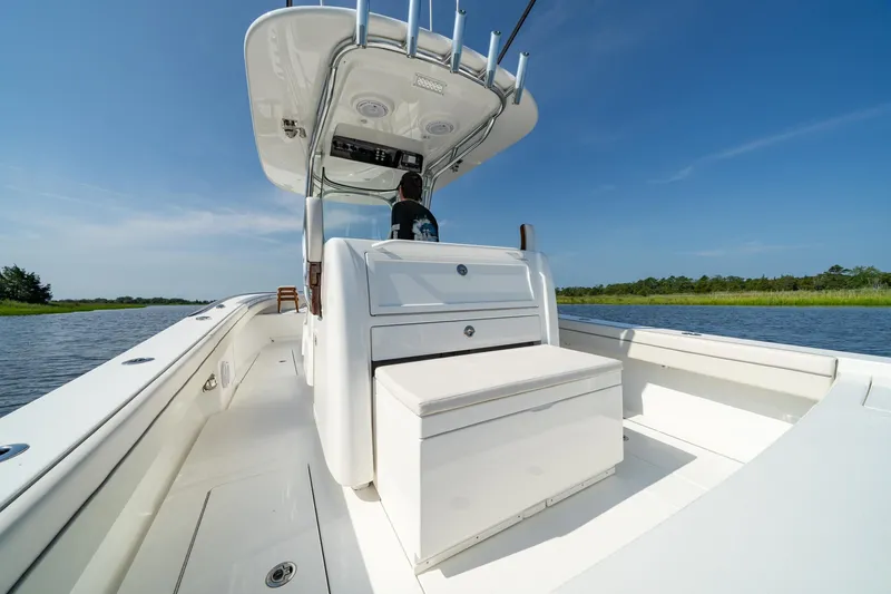 Slide: The Image of 2025 Valhalla Boatworks V-29 Hybrid on calm water, showcasing sleek design and spacious deck. - 14