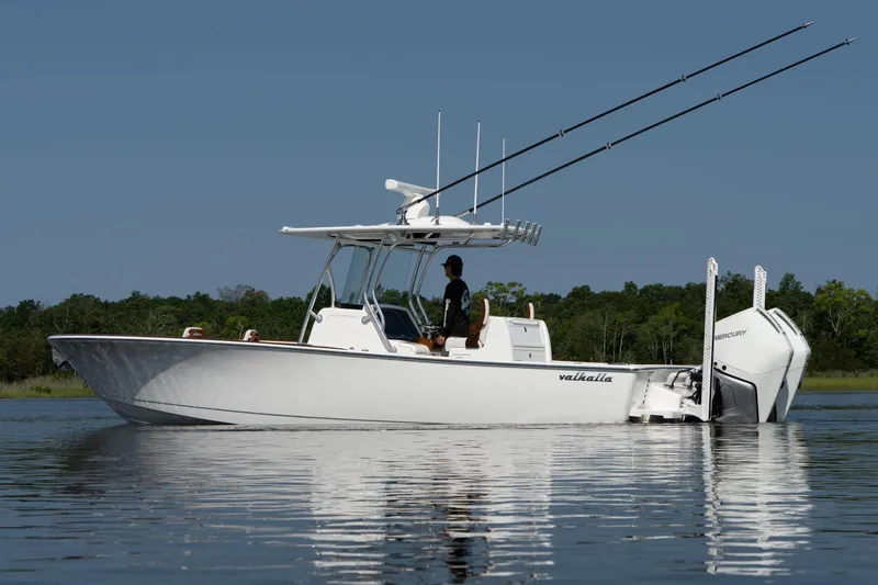 Slide: The Image of 2025 Valhalla Boatworks V-29 Hybrid on calm water, side view with fishing rods. - 4
