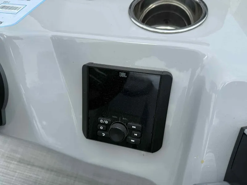 Slide: The Image of 2025 Bentley Pontoons 243 Fish-N-Cruise dashboard with JBL audio system and cup holder. - 11