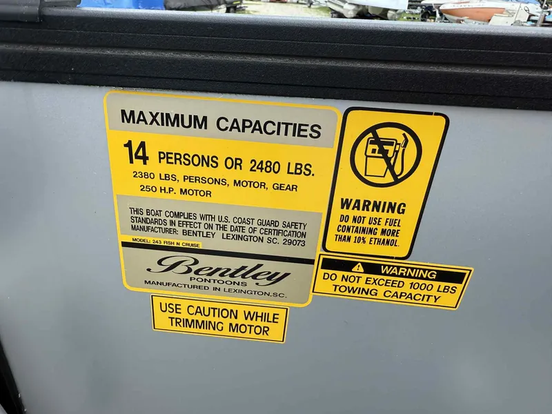 Slide: The Image of 2025 Bentley Pontoons 243 Fish-N-Cruise capacity and safety warning labels. - 13