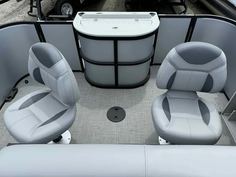 Slide: The Image of 2025 Bentley Pontoons 243 Fish-N-Cruise interior with two gray seats and a console. - 14