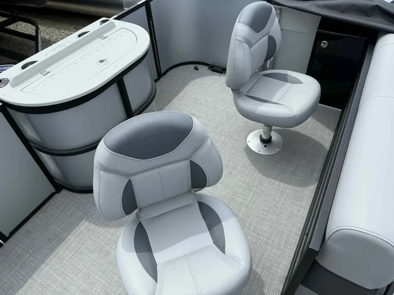 Slide: The Image of 2025 Bentley Pontoons 243 Fish-N-Cruise interior with two swivel seats and fishing station. - 15