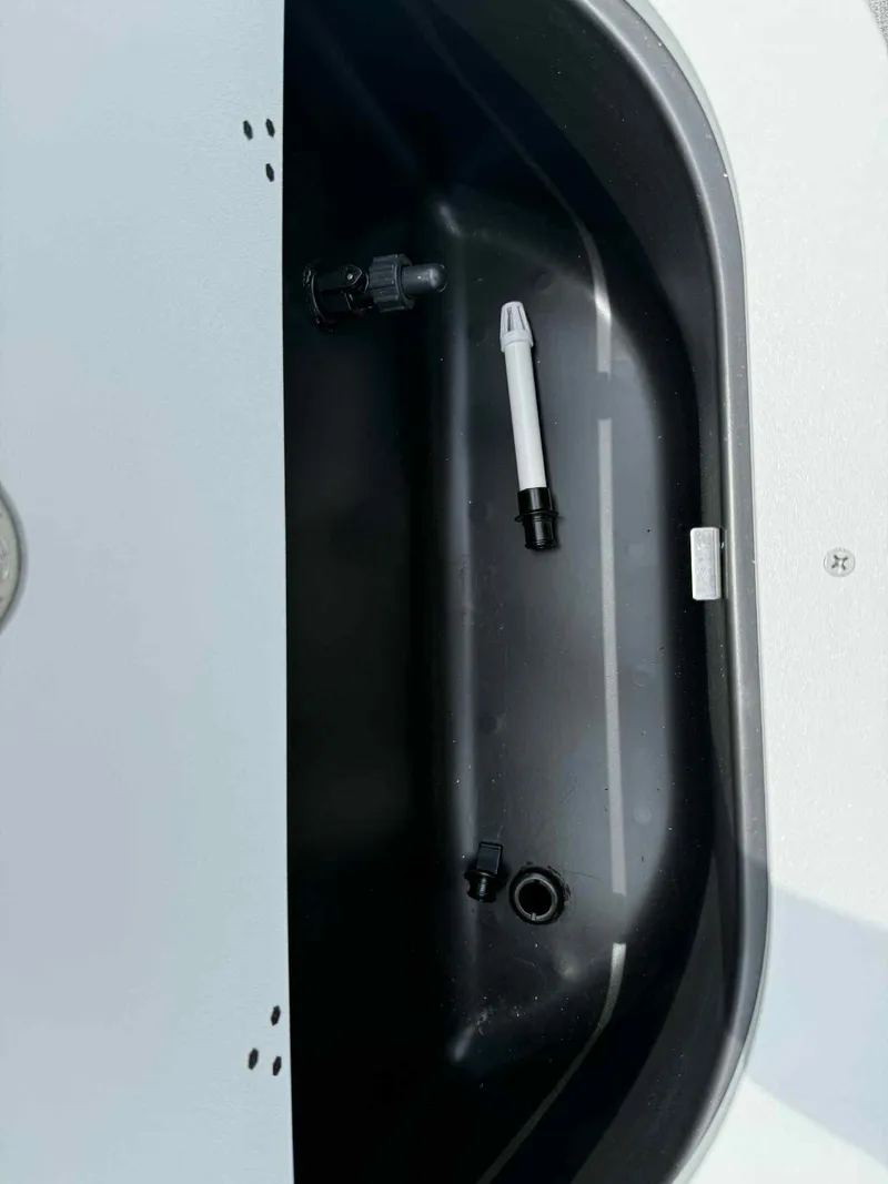 Slide: The Image of 2025 Bentley Pontoons 243 Fish-N-Cruise livewell interior with fittings and components. - 17