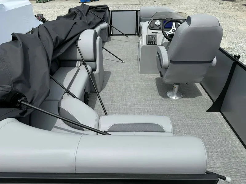 Slide: The Image of 2025 Bentley Pontoons 243 Fish-N-Cruise interior with gray seating and steering console. - 18