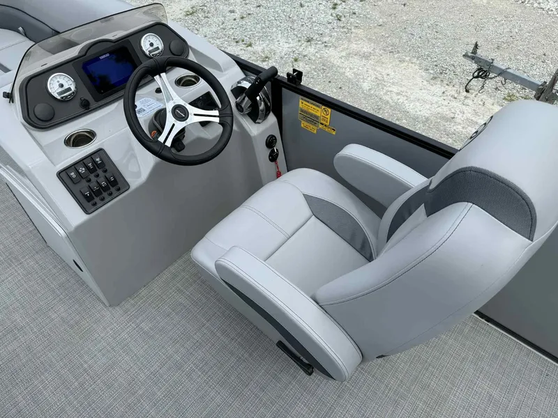 Slide: The Image of 2025 Bentley Pontoons 243 Fish-N-Cruise helm with steering wheel and captain's chair. - 4