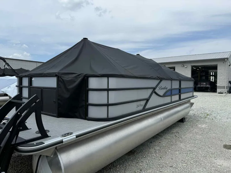 Slide: The Image of 2025 Bentley Pontoons 243 Fish-N-Cruise with cover, parked outdoors on gravel. - 5