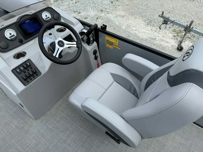 Slide: The Image of 2025 Bentley Pontoons 243 Fish-N-Cruise helm with steering wheel and captain's chair. - 6