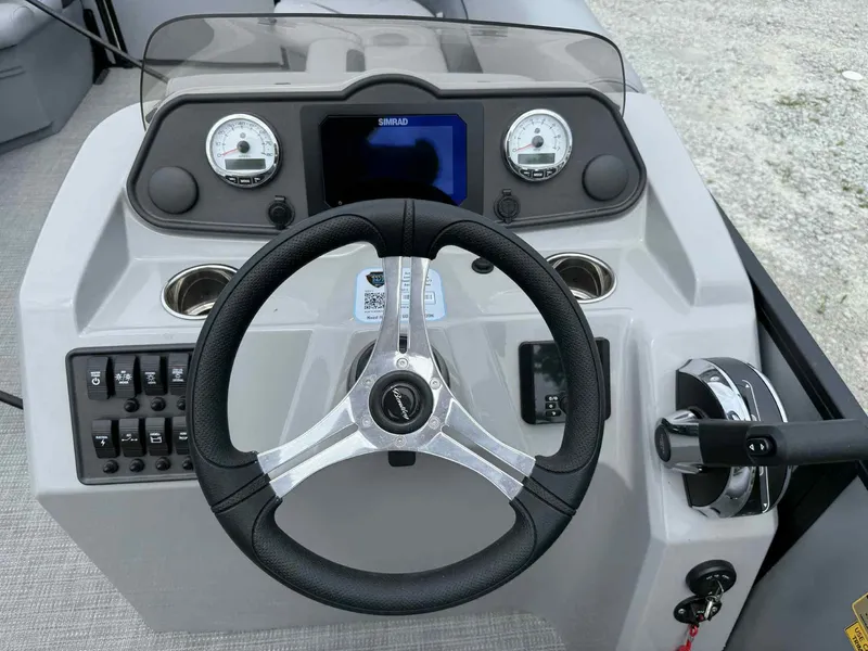 Slide: The Image of 2025 Bentley Pontoons 243 Fish-N-Cruise dashboard with steering wheel and controls. - 8