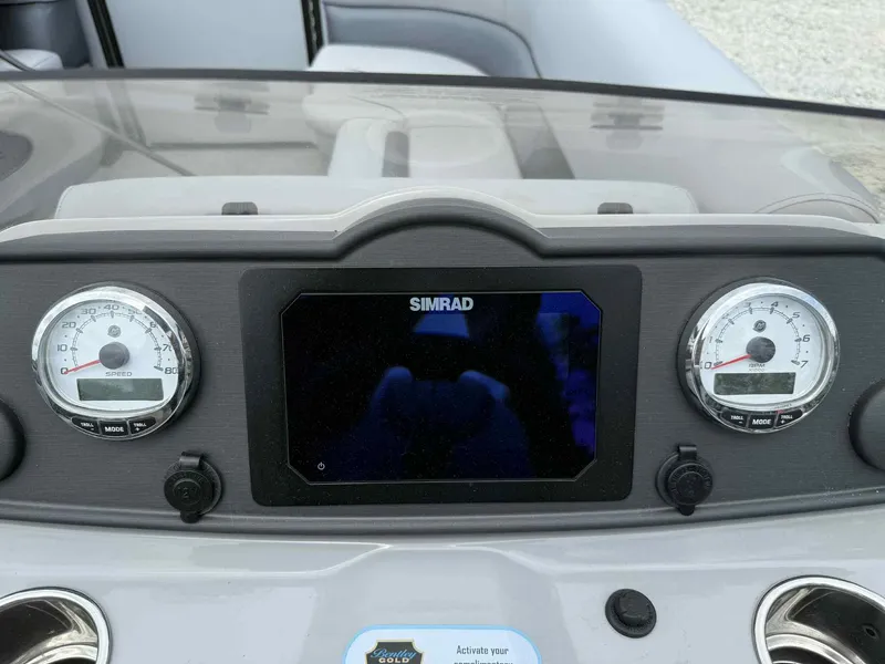 Slide: The Image of Dashboard of 2025 Bentley Pontoons 243 Fish-N-Cruise with Simrad display and gauges. - 9