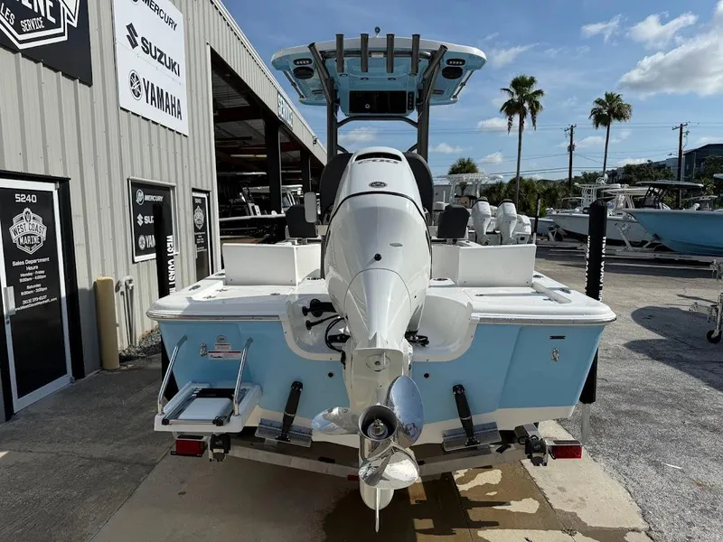 Slide: The Image of 2026 Sea Pro 230 Bay boat at dealership, rear view with outboard motor. - 12