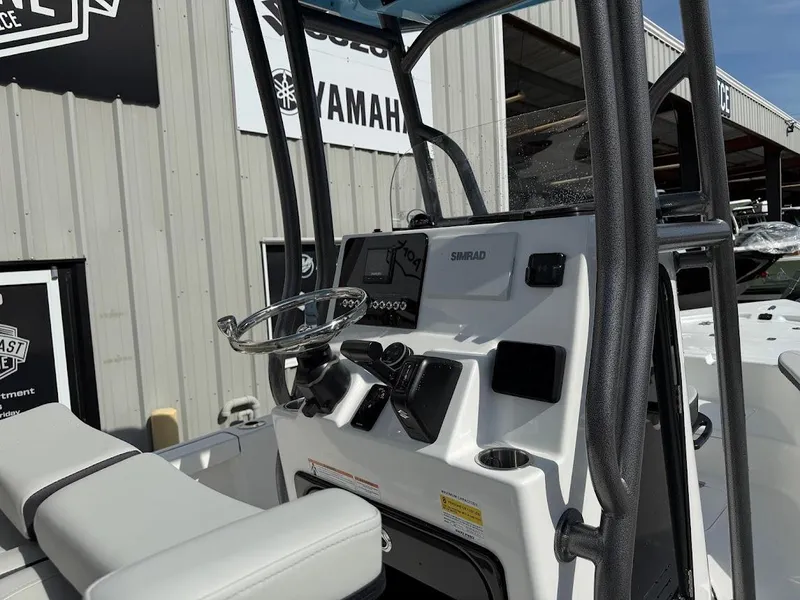 Slide: The Image of 2026 Sea Pro 230 Bay boat console with steering wheel and Simrad electronics. - 13