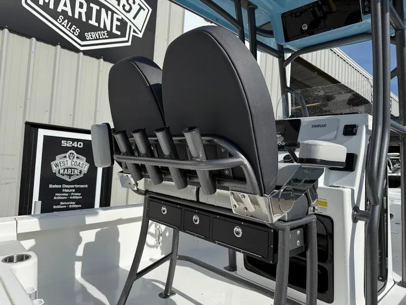 Slide: The Image of 2026 Sea Pro 230 Bay boat interior with rod holders and console at West Coast Marine. - 15