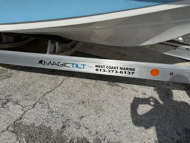 Slide: The Image of 2026 Sea Pro 230 Bay boat on Magic Tilt trailer, West Coast Marine contact visible. - 3