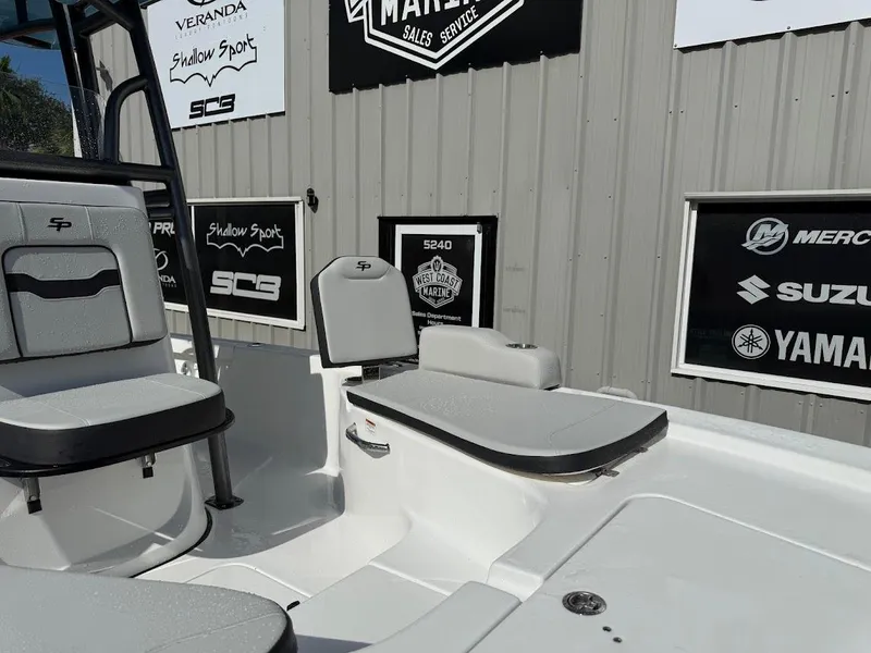 Slide: The Image of 2026 Sea Pro 230 Bay boat interior with seating and branded signage. - 6