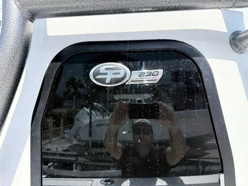 Slide: The Image of 2026 Sea Pro 230 Bay boat logo with reflection on glass surface. - 8