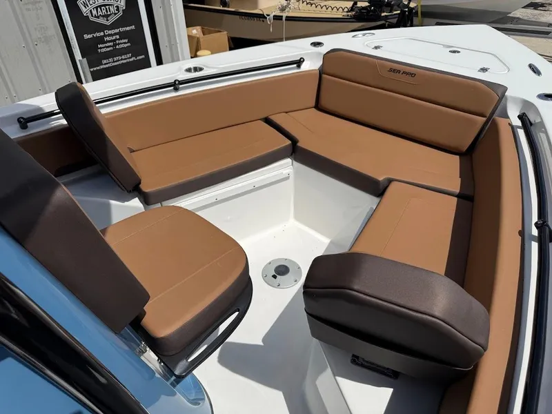 Slide: The Image of 2026 Sea Pro 225 Sandbar boat interior with brown cushioned seating. - 11