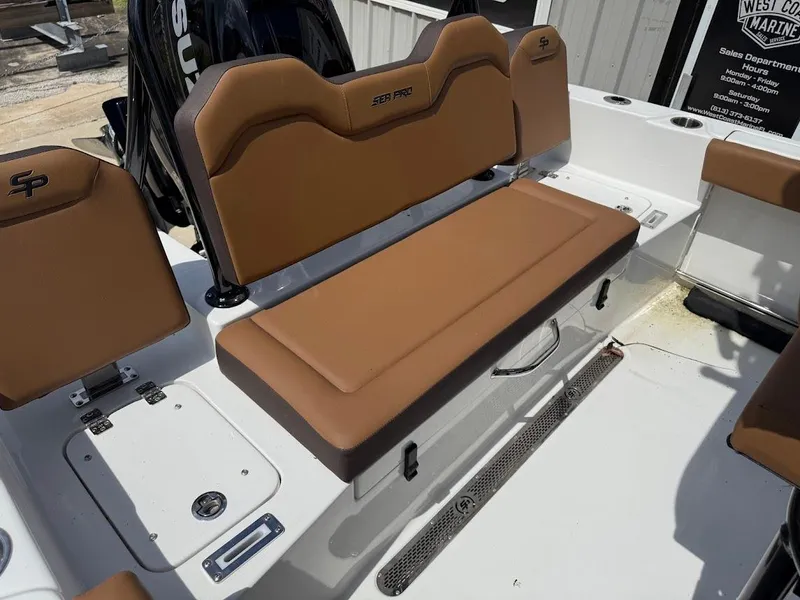 Slide: The Image of 2026 Sea Pro 225 Sandbar boat interior with brown seating and Suzuki engine. - 15