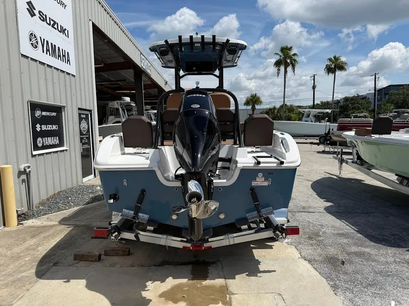 Slide: The Image of 2026 Sea Pro 225 Sandbar boat with outboard motor in a dealership lot. - 7