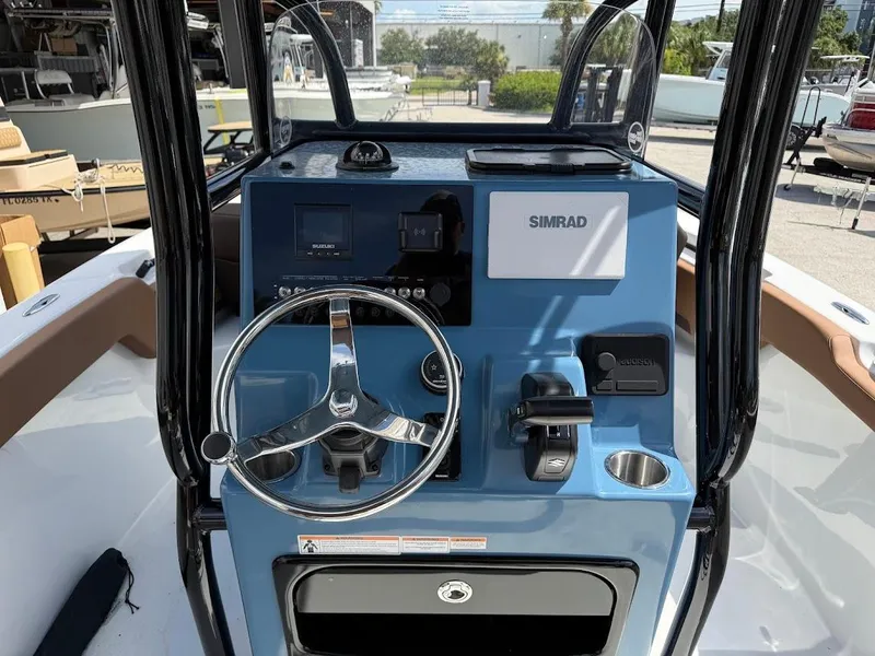 Slide: The Image of 2026 Sea Pro 225 Sandbar boat console with steering wheel and Simrad display. - 9