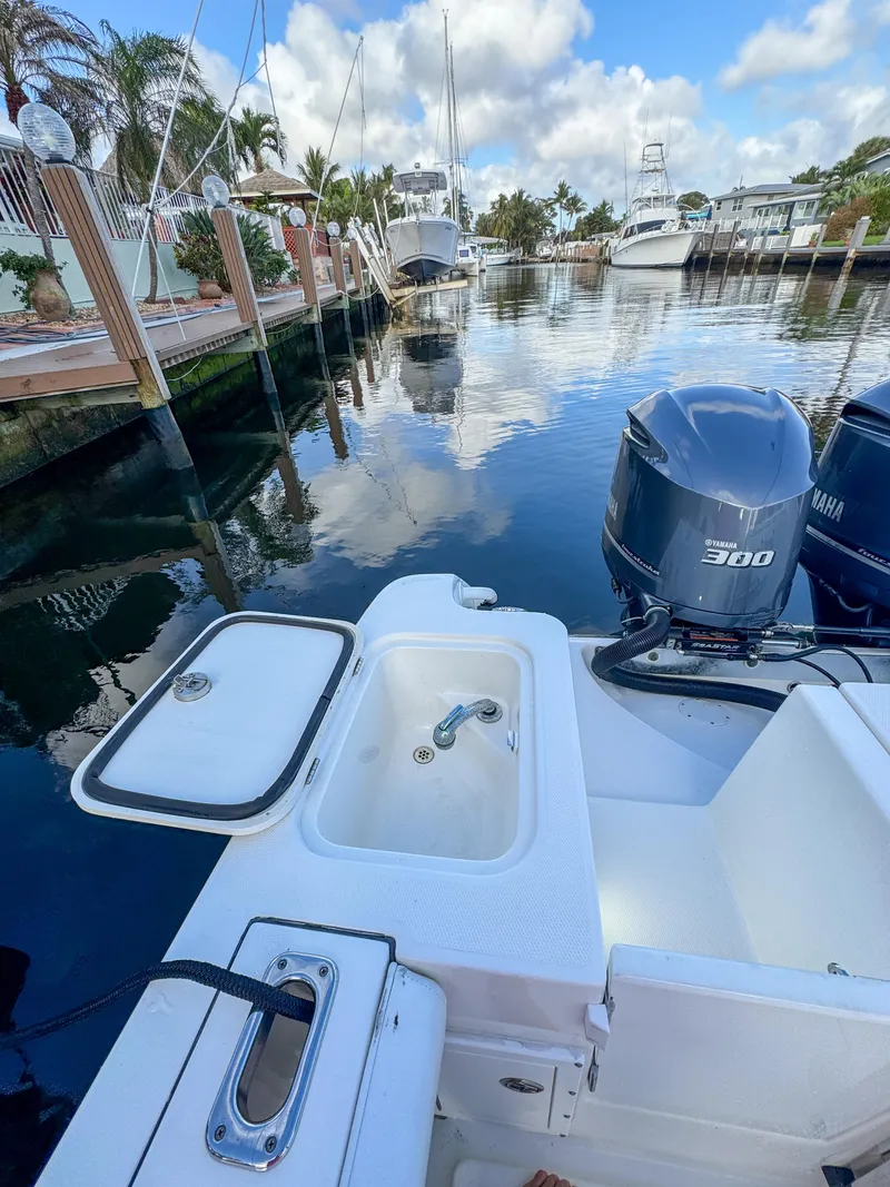 Slide: The Image of 2013 Edgewater 318CC boat with Yamaha 300 engine docked in a marina. - 10