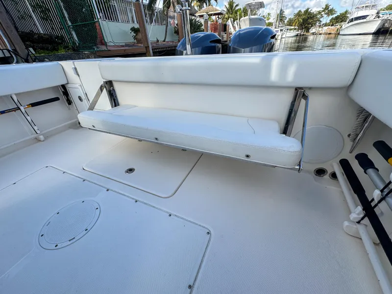 Slide: The Image of 2013 Edgewater 318CC boat interior with foldable bench seat and storage compartments. - 13