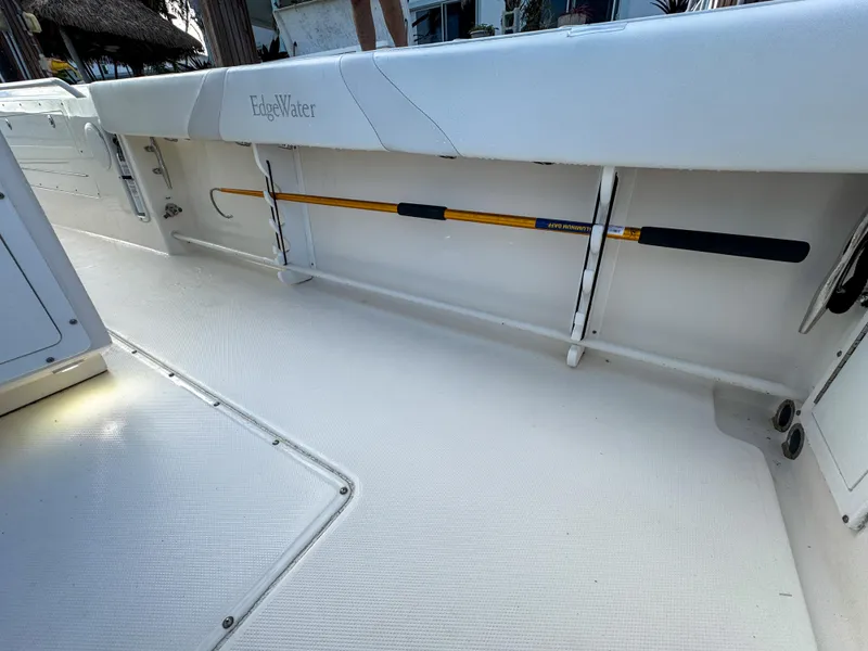 Slide: The Image of 2013 Edgewater 318CC boat interior with fishing rod storage. - 14