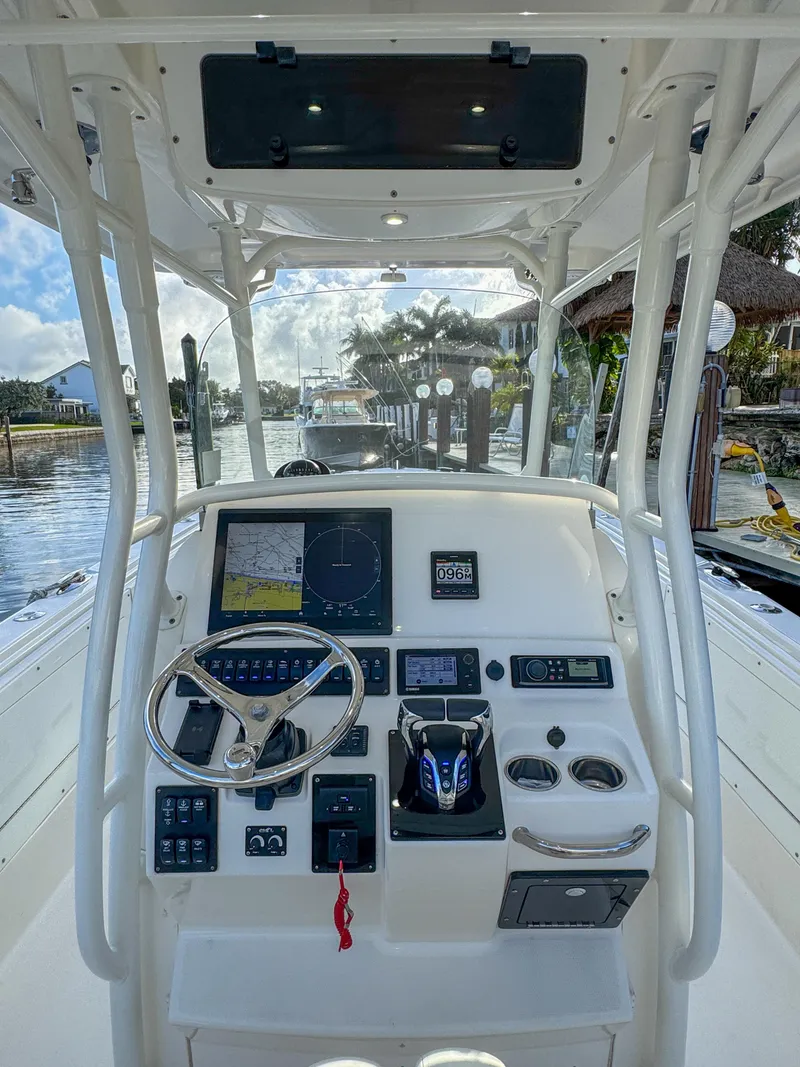Slide: The Image of 2013 Edgewater 318CC boat dashboard with steering wheel and navigation controls. - 21