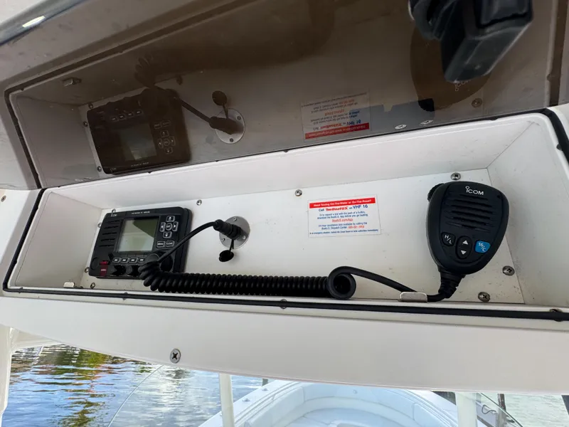 Slide: The Image of 2013 Edgewater 318CC boat console with communication equipment and controls. - 27