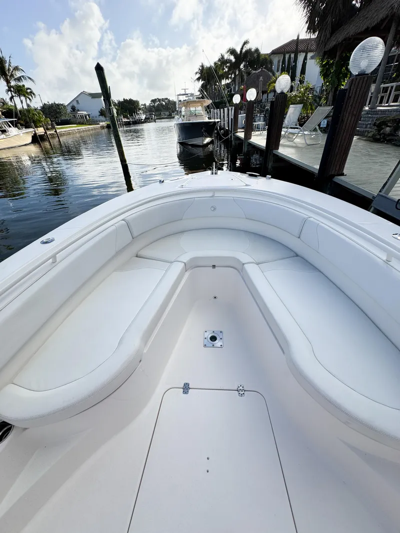 Slide: The Image of 2013 Edgewater 318CC boat docked by a scenic waterfront. - 39