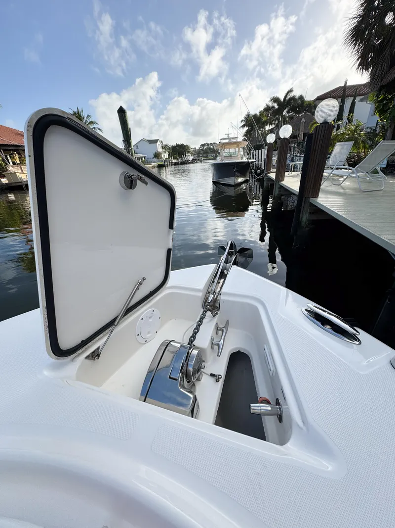 Slide: The Image of 2013 Edgewater 318CC boat docked, open hatch, sunny waterfront view. - 42