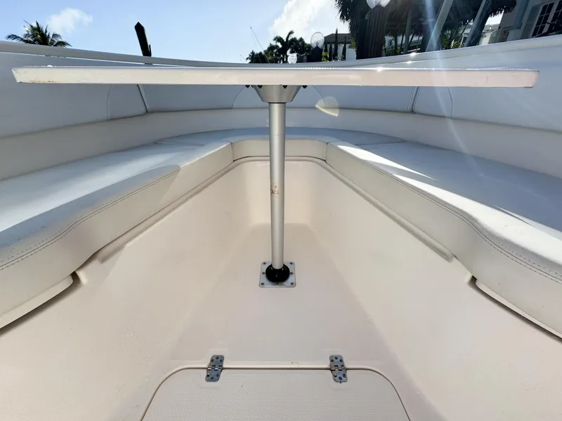 Slide: The Image of 2013 Edgewater 318CC boat interior with seating and table setup. - 45