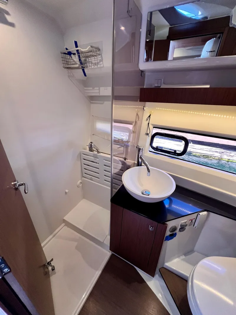 Slide: The Image of 2019 Jeanneau NC 1095 bathroom with modern sink, shower, and window. - 18