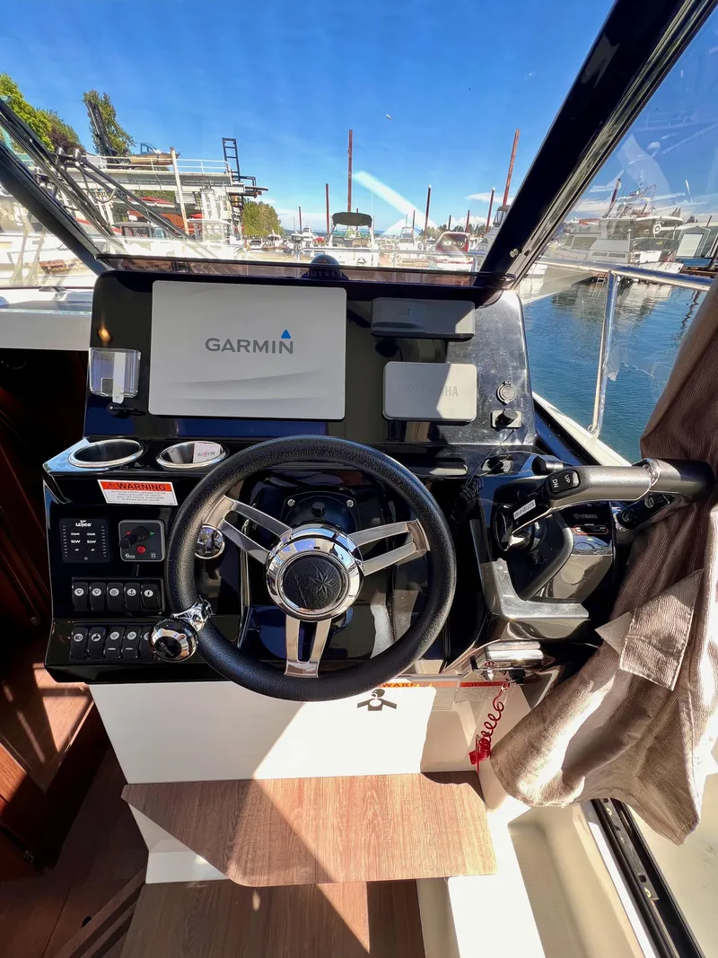 Slide: The Image of 2019 Jeanneau NC 1095 helm with Garmin navigation system, docked at marina. - 8