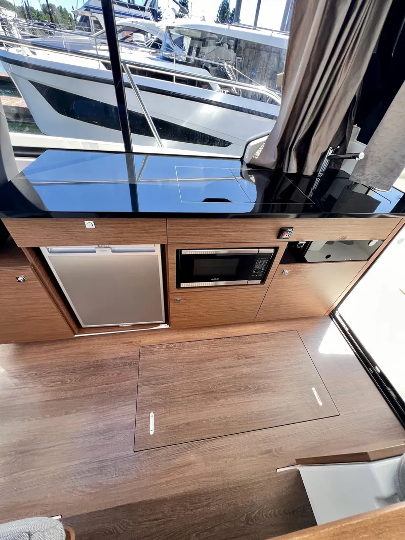 Slide: The Image of Interior of 2019 Jeanneau NC 1095 boat with modern kitchen appliances. - 9