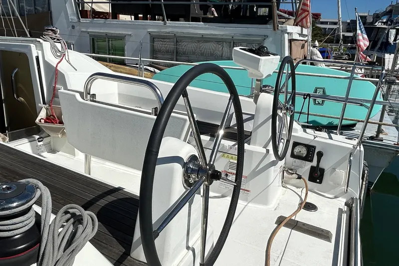 Slide: The Image of 2021 Beneteau Oceanis 30.1 yacht cockpit with dual steering wheels and nautical equipment. - 11